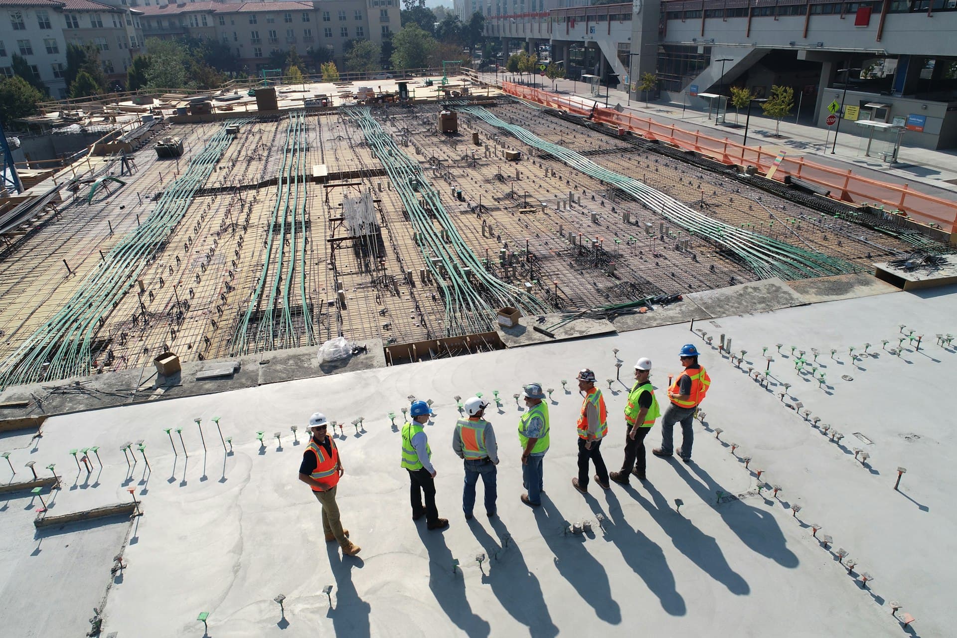 Aerial view of a reinforced-concrete deck under construction, rebar and conduit laid out on the survey grid
